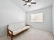 Bright room with white walls, neutral carpet, and a white futon under a ceiling fan at 2736 Huber Heights Dr, Las Vegas, NV 89128