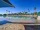 Sandy beach, umbrellas, and the lake reflecting the sky on a sunny day at 2736 Huber Heights Dr, Las Vegas, NV 89128