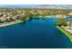 Picturesque lake community showing calm lake, trees and luxury homes on a sunny day at 2736 Huber Heights Dr, Las Vegas, NV 89128