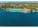 Aerial view of a lagoon style pool, boat docks, lounge chairs, palm trees, and community on the lake at 2736 Huber Heights Dr, Las Vegas, NV 89128
