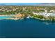 Aerial view of a lagoon style pool and docks with palm trees and community buildings on the lake at 2736 Huber Heights Dr, Las Vegas, NV 89128