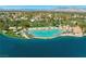 Beautiful aerial view of the sandy community pool, palm trees, lounge chairs, and community on the lake at 2736 Huber Heights Dr, Las Vegas, NV 89128