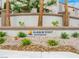 Entrance to Harbor Point, a Desert Shores community, with a stone sign and desert landscaping at 2736 Huber Heights Dr, Las Vegas, NV 89128