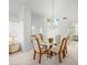 Bright dining area with a glass table, chandelier, and large mirror, adjacent to the kitchen at 2736 Huber Heights Dr, Las Vegas, NV 89128