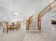 Elegant entryway featuring a curved staircase, marble floors, and a formal dining area with chandelier at 2736 Huber Heights Dr, Las Vegas, NV 89128