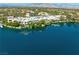 Panoramic view of luxury waterfront homes with red tile roofs and the lake in the foreground at 2736 Huber Heights Dr, Las Vegas, NV 89128