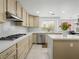 Bright kitchen features a gas range, stainless appliances, and quartz countertops at 2736 Huber Heights Dr, Las Vegas, NV 89128