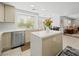 Bright kitchen features white countertops, stainless steel appliances, and a breakfast bar island at 2736 Huber Heights Dr, Las Vegas, NV 89128
