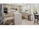 Well-lit kitchen showcasing stainless steel appliances, a center island with stone countertop, and modern cabinetry at 2736 Huber Heights Dr, Las Vegas, NV 89128