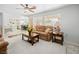 Open-concept living room, light-colored carpeting, and modern furnishings with large windows at 2736 Huber Heights Dr, Las Vegas, NV 89128