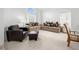 Comfortable living room with neutral carpeting and light-colored sofas with decorative pillows at 2736 Huber Heights Dr, Las Vegas, NV 89128