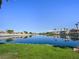 Picturesque view of a tranquil lake lined with beautiful homes in a lakeside community at 2736 Huber Heights Dr, Las Vegas, NV 89128