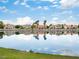Scenic water view with reflections of the homes and sky, highlighting the serene lakeside living at 2736 Huber Heights Dr, Las Vegas, NV 89128