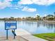 Scenic Desert Shores waterfront view featuring lush landscaping, calm waters, and luxurious community homes at 2736 Huber Heights Dr, Las Vegas, NV 89128