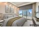 Serene bedroom with city views from large windows, complemented by neutral decor and soft lighting at 2777 Paradise Rd # 2701, Las Vegas, NV 89109