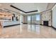 Open-concept living space featuring a modern kitchen, marble floors, and a fireplace at 2777 Paradise Rd # 2701, Las Vegas, NV 89109
