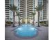 Beautiful pool area with palm trees, lounge seating, and a view of a modern high-rise at 2777 Paradise Rd # 2701, Las Vegas, NV 89109
