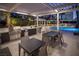 Outdoor kitchen and dining area next to the pool with stainless steel appliances and comfortable seating at 2777 Paradise Rd # 2701, Las Vegas, NV 89109
