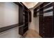 Organized walk-in closet with dark wood shelving and hanging rods provides ample storage at 2777 Paradise Rd # 2701, Las Vegas, NV 89109