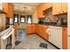 Modern kitchen featuring wooden cabinets, granite countertops, stainless steel appliances, and an open layout at 2822 La Palma Dr, Laughlin, NV 89029
