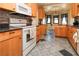 Well-lit kitchen showcasing wooden cabinets, modern appliances, and a stylish backsplash with a view of the breakfast nook at 2822 La Palma Dr, Laughlin, NV 89029