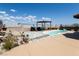 Inviting kidney-shaped pool with a shaded pergola and desert landscaping creates a relaxing outdoor oasis at 2822 La Palma Dr, Laughlin, NV 89029
