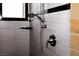 Elegant shower with stone accents, shower head, shelf, and a window at 2822 La Palma Dr, Laughlin, NV 89029