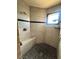 Custom shower features a stone floor, built-in bench, and shower head at 2822 La Palma Dr, Laughlin, NV 89029