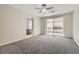 Bright bedroom featuring plush carpeting and sliding glass doors leading to a private patio at 285 Canyon Spirit Dr, Henderson, NV 89012
