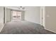 Bedroom with plush carpeting and sliding glass doors leading to a covered outdoor patio at 285 Canyon Spirit Dr, Henderson, NV 89012
