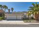 Charming single-story home with a spacious three-car garage and lush tropical landscaping at 285 Canyon Spirit Dr, Henderson, NV 89012