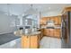 Modern kitchen with a granite island, stainless steel appliances, and open layout to the living area at 285 Canyon Spirit Dr, Henderson, NV 89012