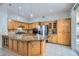 Updated kitchen with stainless steel appliances, granite countertops, and ample wood cabinetry at 285 Canyon Spirit Dr, Henderson, NV 89012