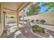 Backyard patio area features a covered pergola, manicured landscaping, and gravel ground cover at 285 Canyon Spirit Dr, Henderson, NV 89012