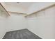 Spacious walk-in closet with carpet flooring and ample storage with wood rods and shelving at 285 Canyon Spirit Dr, Henderson, NV 89012
