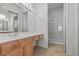 Bright bathroom with a long vanity, mirrors, decorative lights, and glass enclosed shower at 2868 Foxtail Creek Ave, Henderson, NV 89052