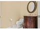 Elegant half bathroom featuring a decorative mirror and an ornate vanity cabinet at 2868 Foxtail Creek Ave, Henderson, NV 89052