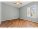 This bedroom boasts hardwood floors, natural light from the window, and neutral walls at 2868 Foxtail Creek Ave, Henderson, NV 89052