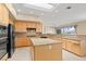 Eat-in kitchen features granite counters, stainless appliances, and island with skylight at 2868 Foxtail Creek Ave, Henderson, NV 89052
