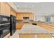 Kitchen features granite countertops and stainless-steel appliances for a modern touch at 2868 Foxtail Creek Ave, Henderson, NV 89052
