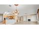 Open-concept living room with a chandelier, fireplace, kitchen, and ample space at 2868 Foxtail Creek Ave, Henderson, NV 89052