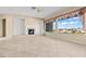 Spacious living room featuring tile floors, fireplace, ceiling fan, and lots of windows at 2868 Foxtail Creek Ave, Henderson, NV 89052