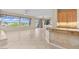 Open concept living room with tile flooring, backyard access, and granite bar at 2868 Foxtail Creek Ave, Henderson, NV 89052
