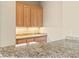 Wet bar features granite counters, wood cabinets, under cabinet lighting, and a sink at 2868 Foxtail Creek Ave, Henderson, NV 89052