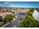 Aerial perspective of a gated community entrance surrounded by well-manicured landscaping and desert homes at 3120 Inlet Bay Ave, North Las Vegas, NV 89031