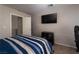 Bedroom with a wall-mounted television and a sliding door closet at 3120 Inlet Bay Ave, North Las Vegas, NV 89031