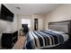 Bedroom with a blue and white striped bedspread and a desk area with an office chair at 3120 Inlet Bay Ave, North Las Vegas, NV 89031