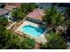 Aerial view of a sparkling community pool surrounded by mature trees and manicured landscaping at 3120 Inlet Bay Ave, North Las Vegas, NV 89031