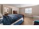 Spacious main bedroom featuring neutral decor, carpeted floors, and a comfortable queen-sized bed at 3120 Inlet Bay Ave, North Las Vegas, NV 89031