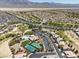 Expansive aerial view showcasing the community layout, golf course, and stunning mountain backdrop at 3312 Lapwing Dr, North Las Vegas, NV 89084